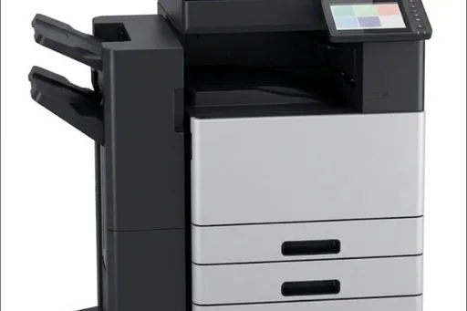 A compact A4 multifunction printer on a timber desk in a small office
