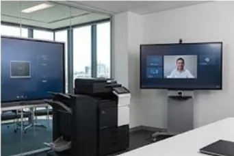 A wall mounted interactive touch display in a small meeting room, a simple diagram on the screen and eucalypts through the window